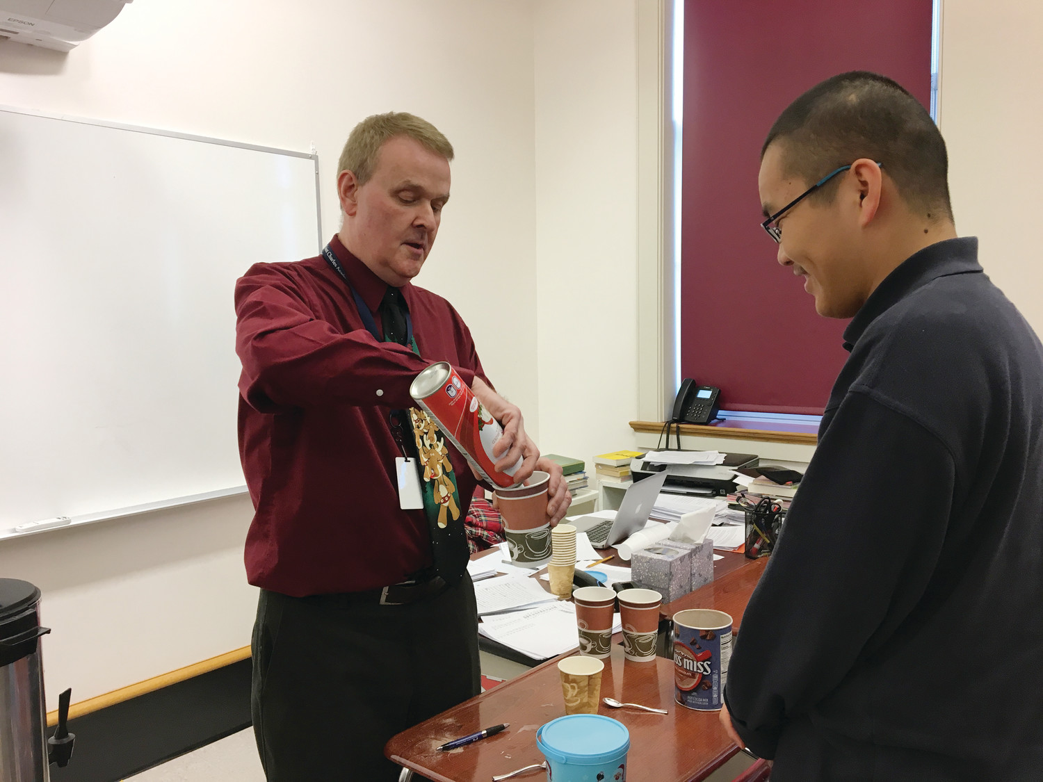 John Guevremont, English Department chair, makes hot chocolate with Wei (Peter) Li, a student from China. Guevremont shared that the exchange students at Mount Saint Charles Academy are “diligent, hardworking, respectful and appreciative.”